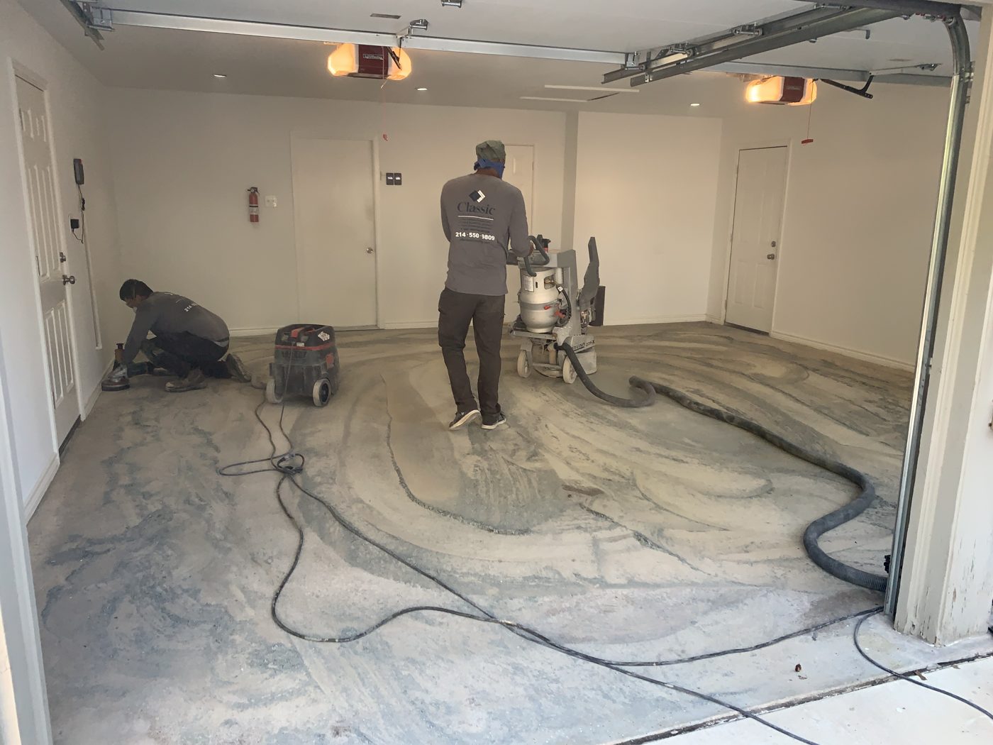 Classic installer diamond grinding a garage floor before coating